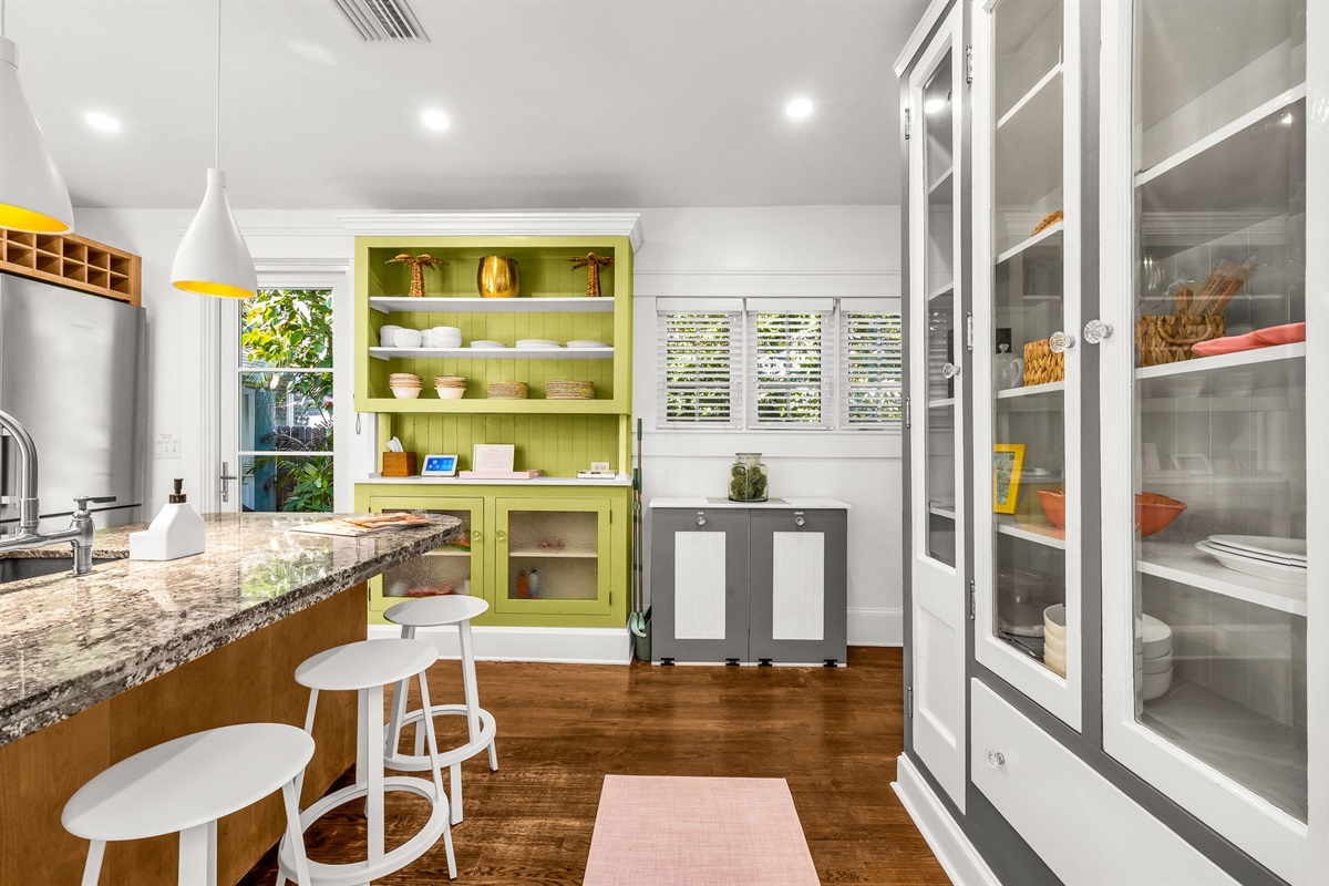 This fully equipped kitchen features a gas range stove, Nespresso, Keurig, and drip coffee makers, plus a blender and serviceware for 10. French doors lead directly to the patio with an outdoor dining table for 6—perfect for al fresco meals in paradise.