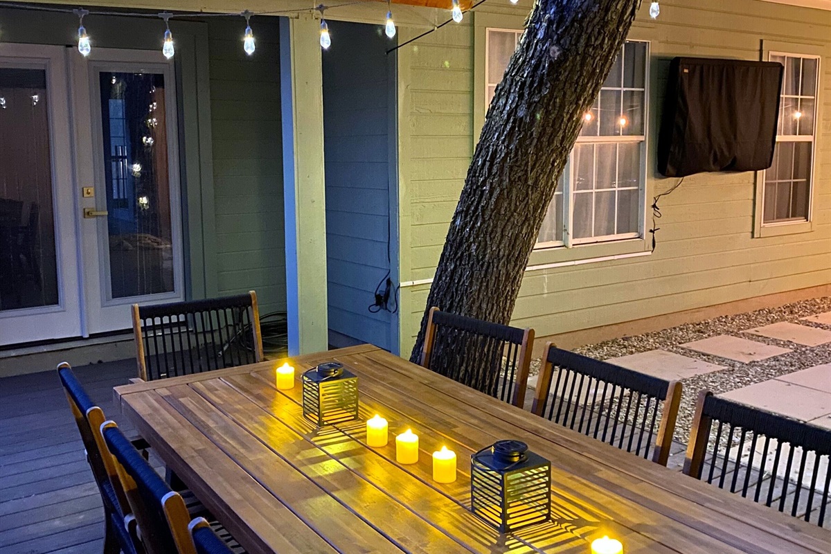 Dine outdoors beneath the gentle glow of string lights and candlelit lanterns. Our stylish patio setup creates a serene, inviting ambiance for memorable evenings. Enjoy a refined and relaxing experience in this beautiful open-air space.