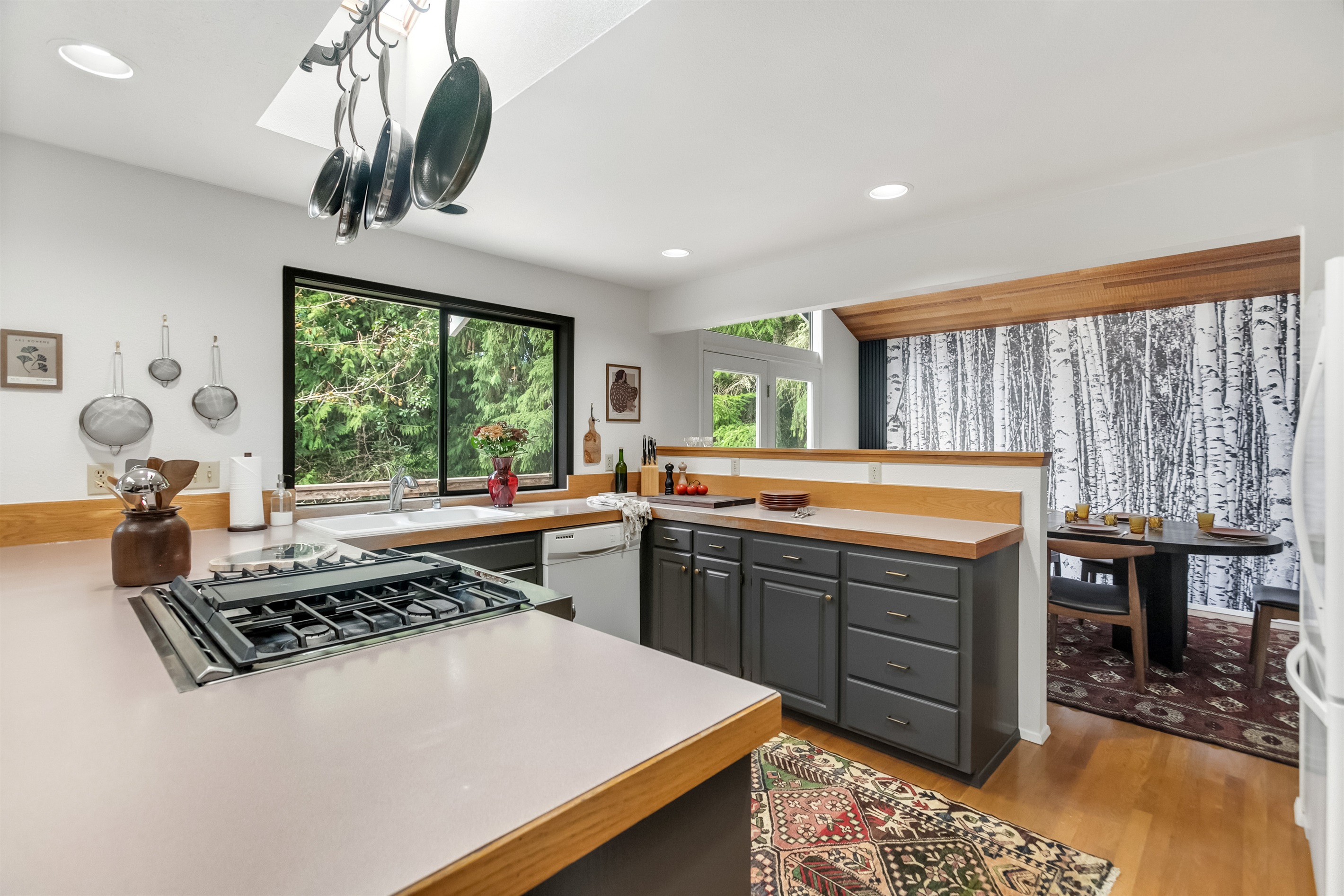 The spacious kitchen comes fully equipped with cooking utensils and tableware.