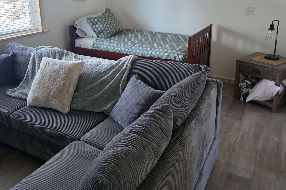 Loft area includes sectional sofa and additional bed (twin bed with trundle bed).