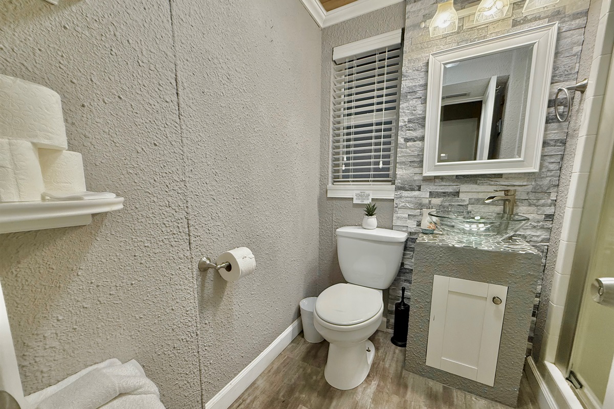 Equipped with modern lighting, beautiful tile work, and all the essentials—this space is practical and peaceful.