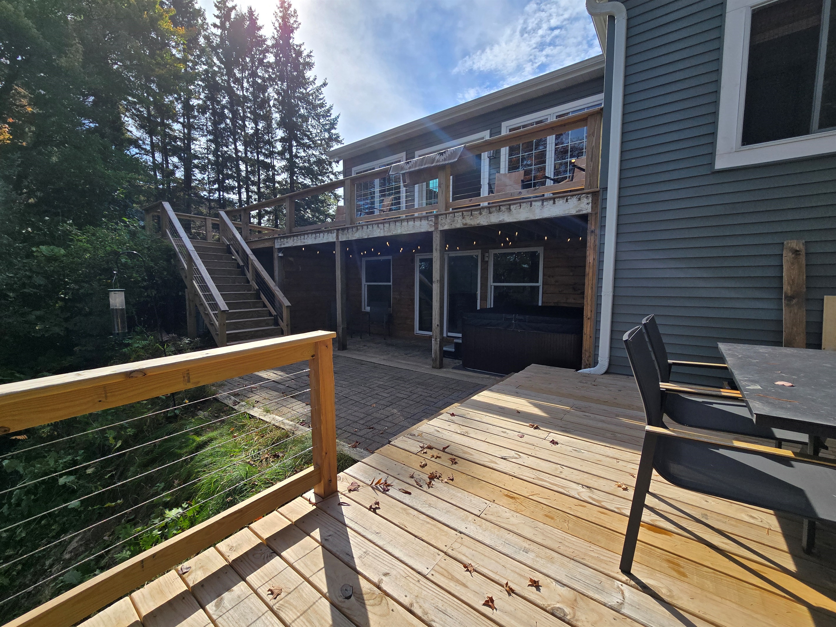 Unwind in our covered lakeside hot tub with stunning views! ✨ Enjoy bubbling water, peaceful nature, and vibrant trees—perfect for sunrise coffee or a relaxing sunset soak. 🌲🌅