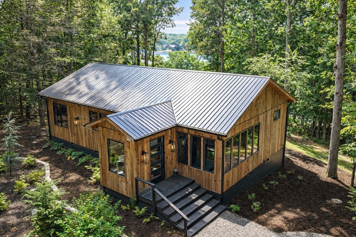 A stunning modern retreat with floor-to-ceiling windows and spacious outdoor living.