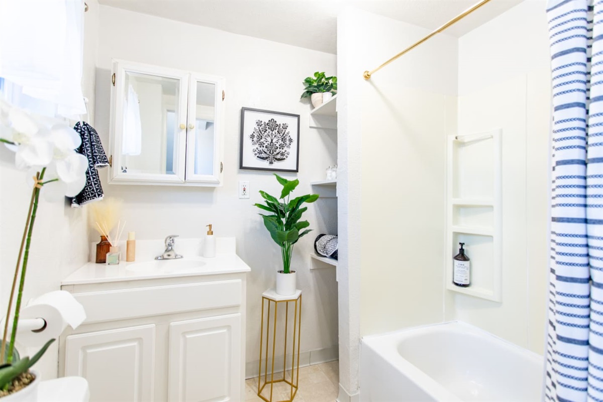 A full bathroom featuring a relaxing bathtub, along with essential fixtures like a sink and toilet, creating a complete and functional space for comfort and convenience.
