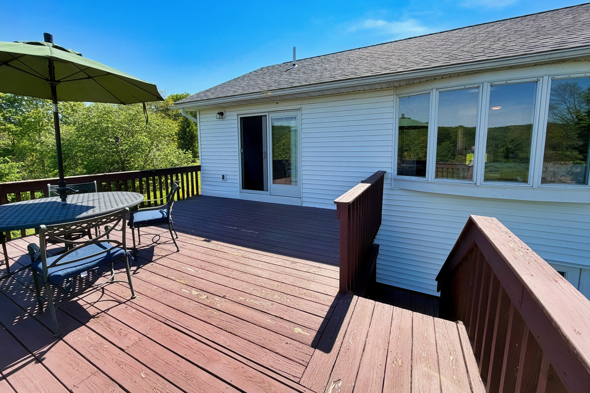 Back deck with seating overlooking the backyard