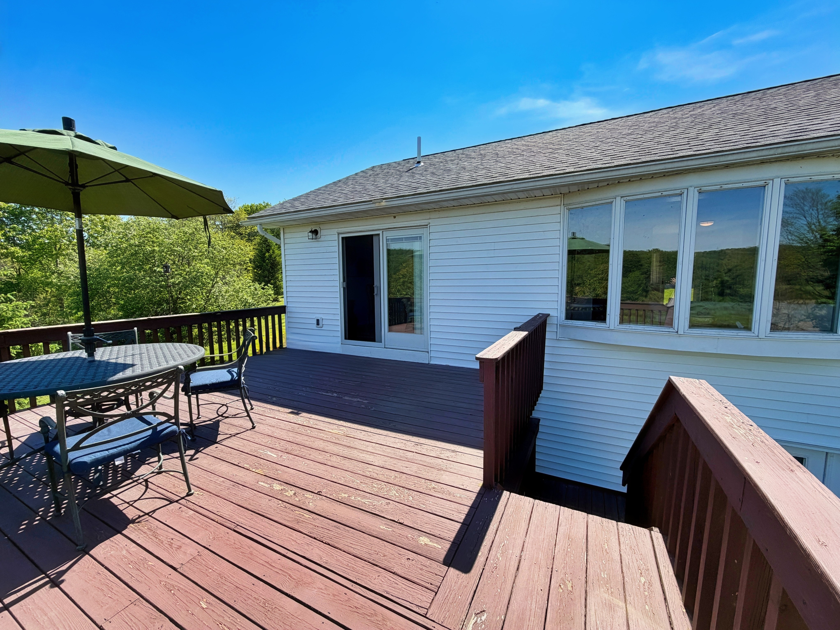 Back deck with seating overlooking the backyard