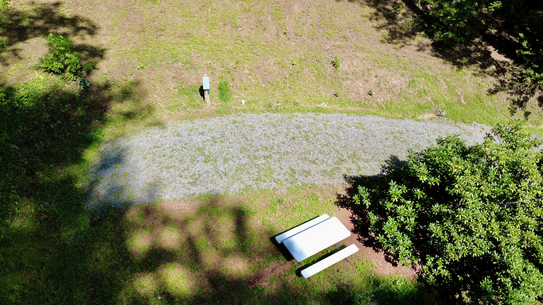 Your home base in the mountains — Site 3 is ready for RVs under 30 ft with full hookups & picnic seating.