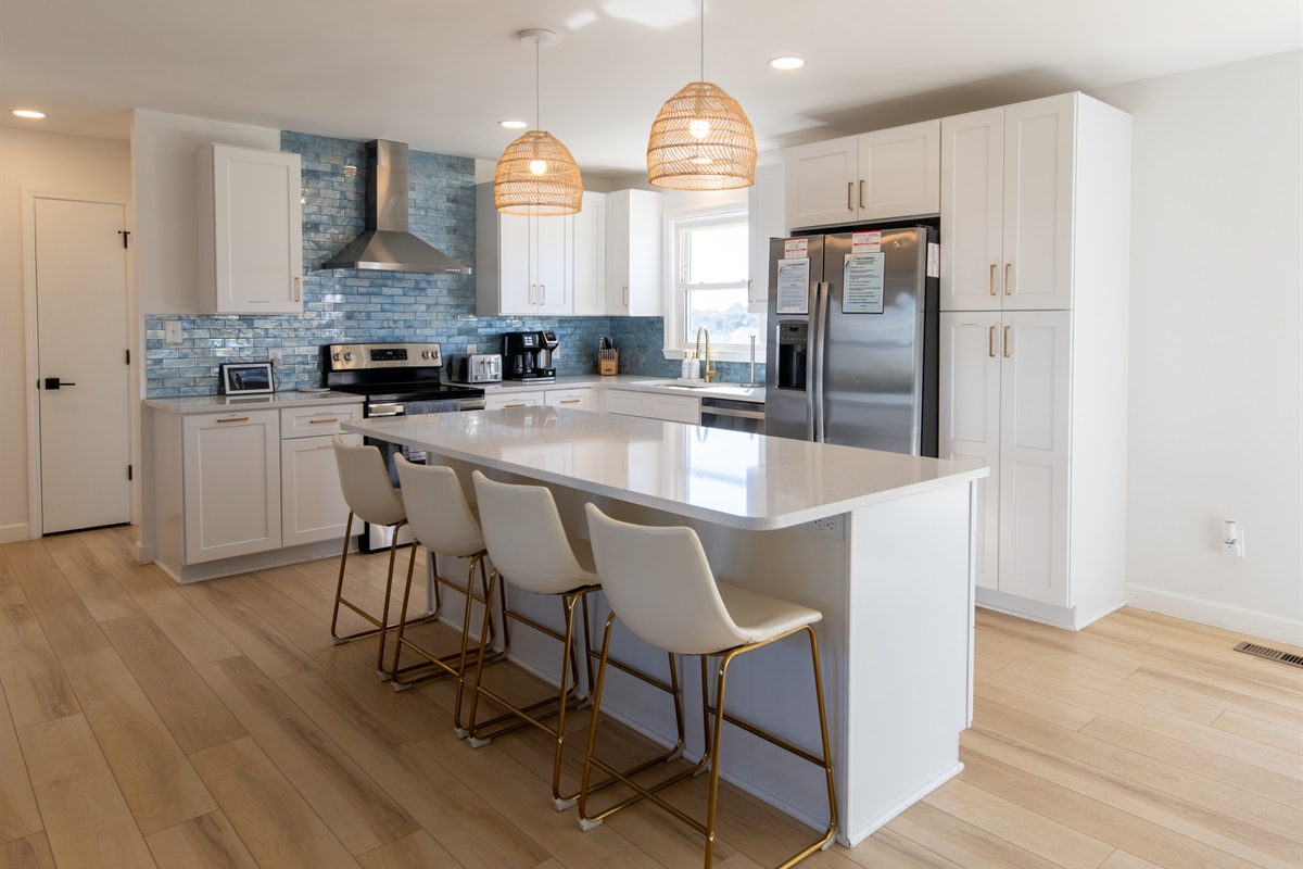 4-seat island separates the kitchen from the rest of the open floor plan room. The kitchen has plenty of space, storage, and all you'll need while at Treasure Chest. Cooking is a pleasure in this bright, beautiful, and well-stocked kitchen