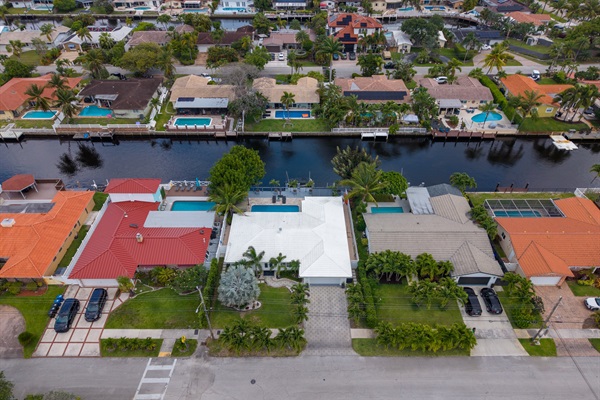 Luxury waterfront home with tropical curb appeal