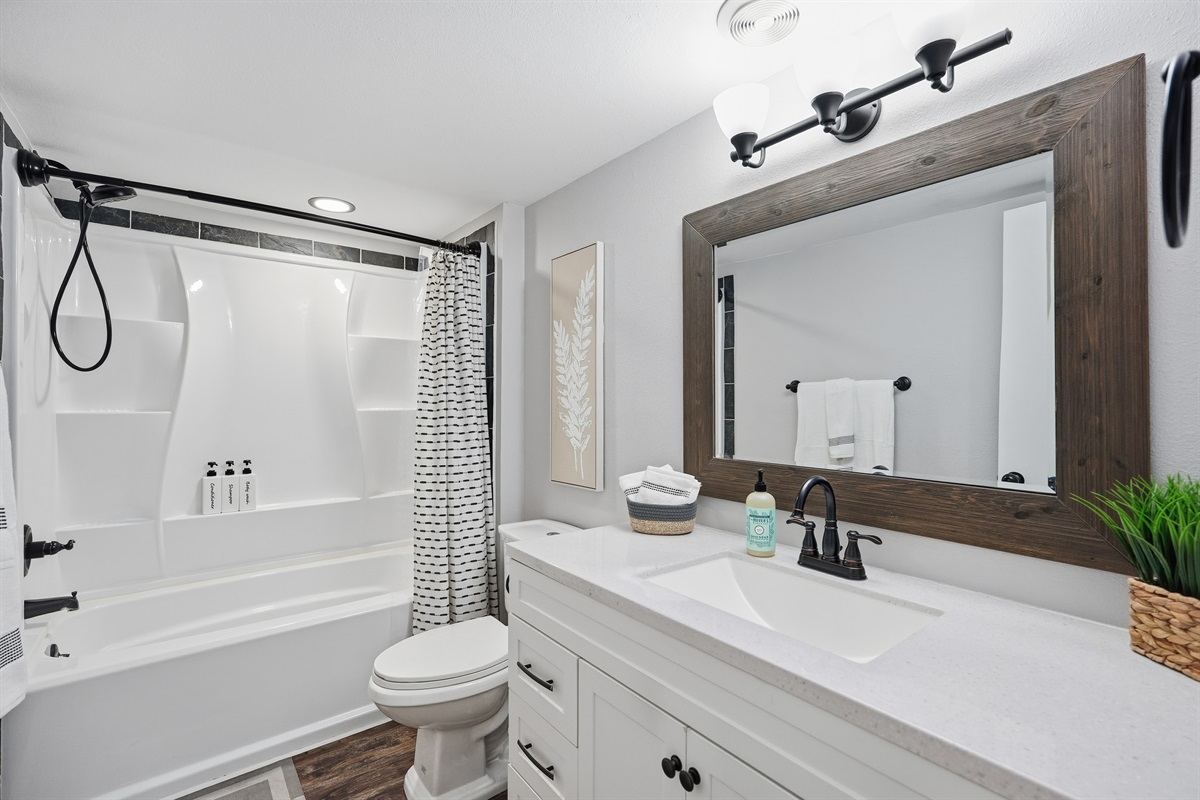 Stylish bathroom featuring soaking tub, sleek vanity, plush towels, and spa-inspired comforts