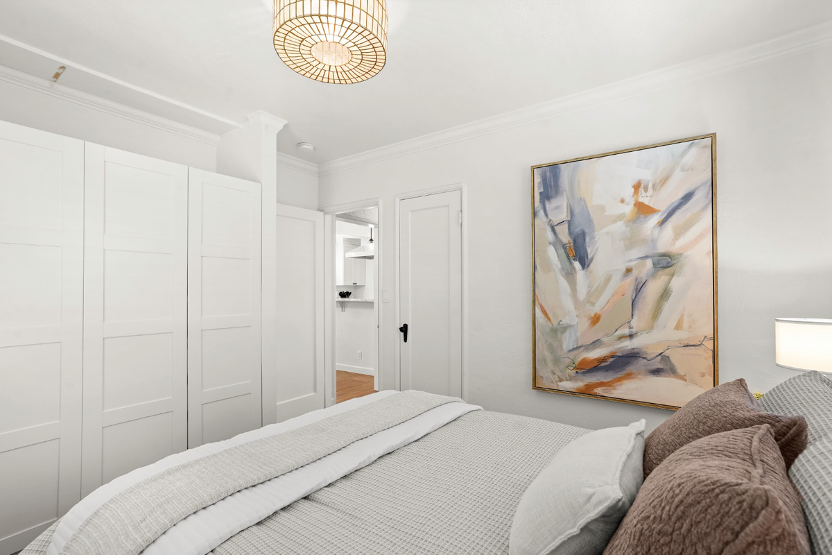 Rest easy in a serene queen bedroom filled with natural light