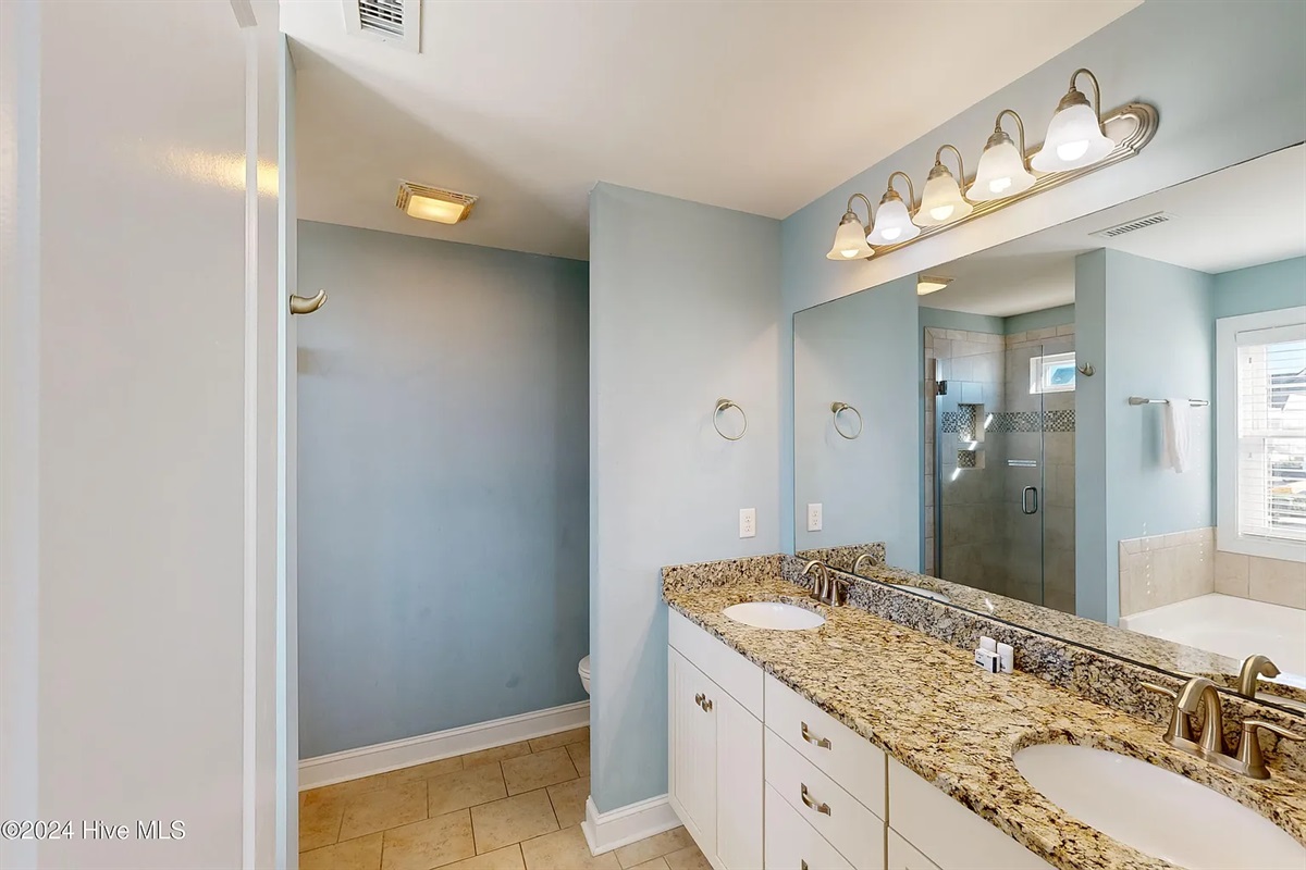Pristine bathroom featuring modern fixtures and plenty of storage