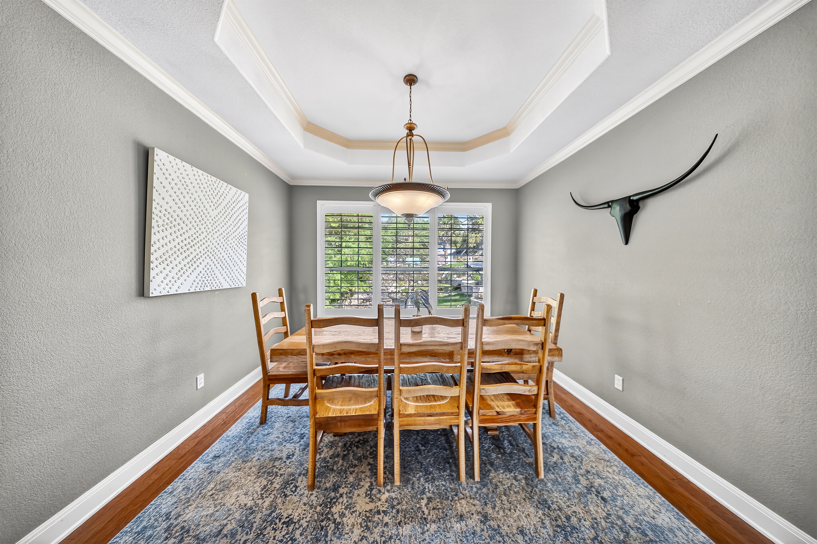The dining room, conveniently located off the kitchen, provides an ideal setting for family meals. 