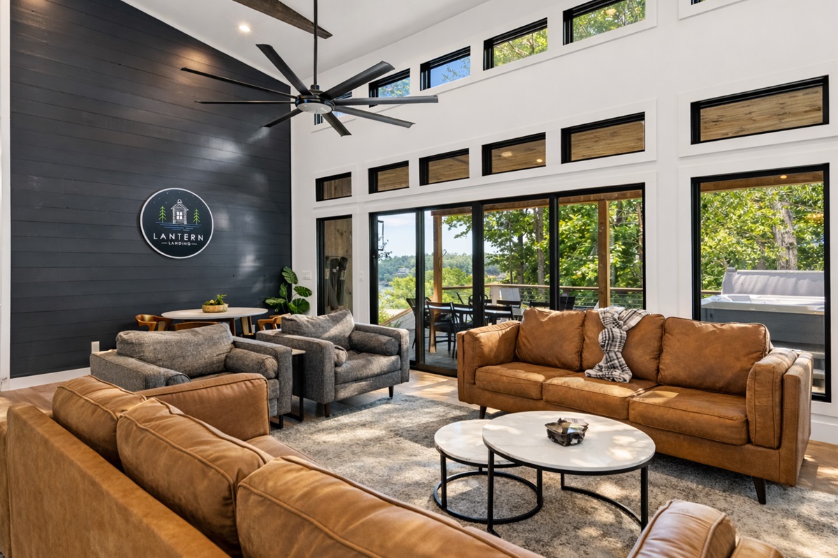 Expansive windows fill the space with natural light, enhancing the cozy yet modern ambiance of the cabin.