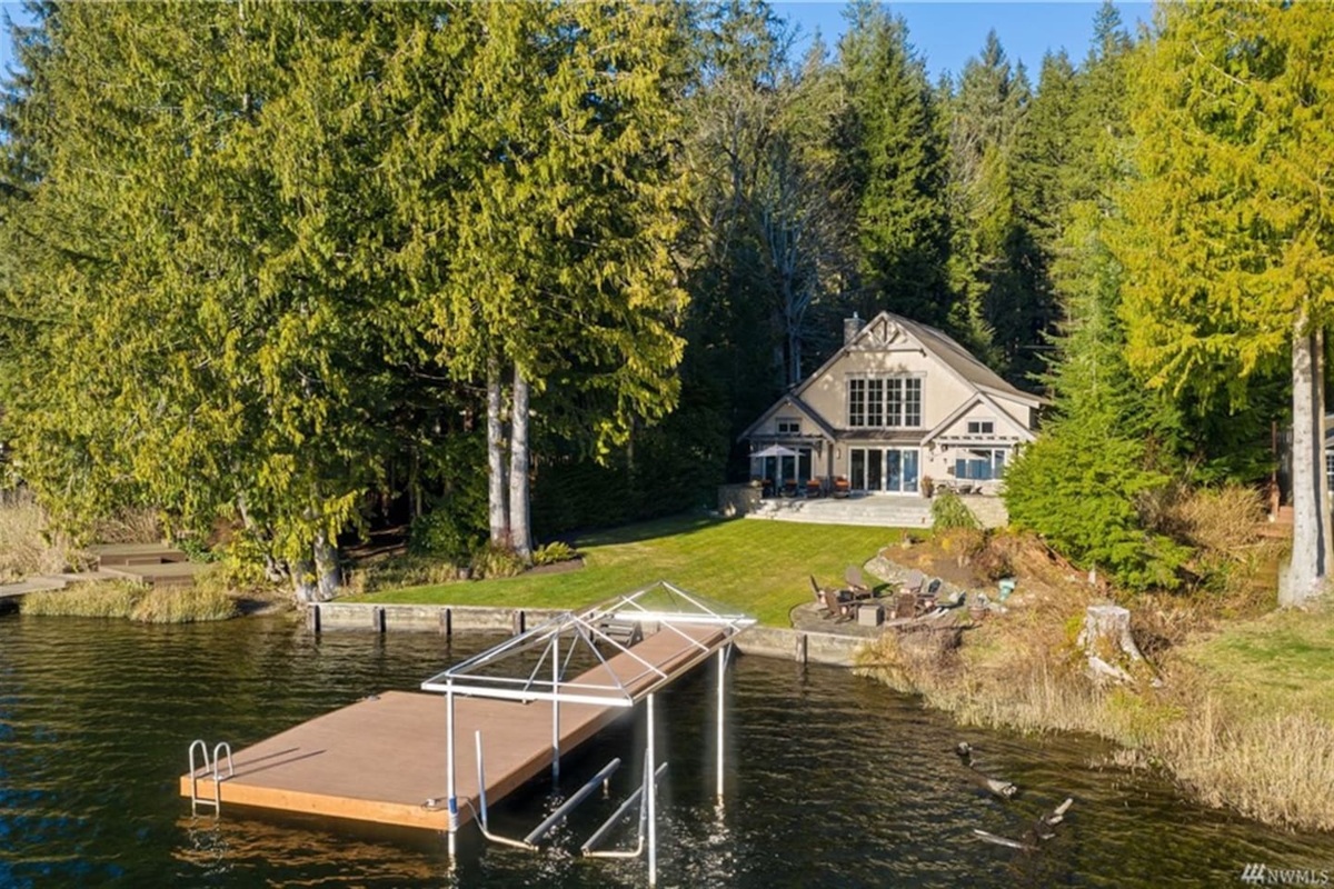 Serene dock view highlighting the house and waterfront setting.