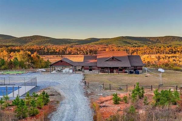 Sunrise aerial highlighting the cabin’s elevated ridge location.