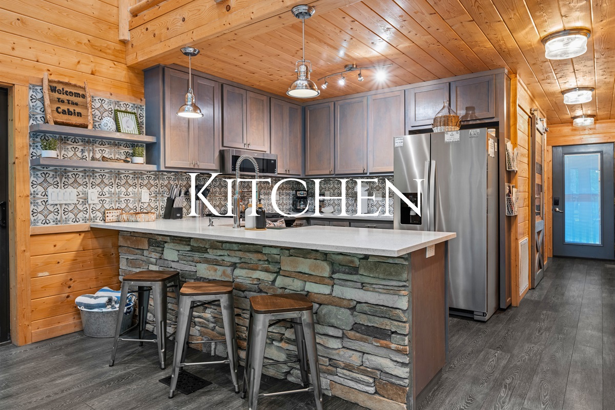 The kitchen blends rustic cabin charm with modern convenience, giving you everything you need for cooking and entertaining.