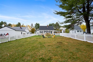 Fenced backyard with firepit and 4 patio chairs