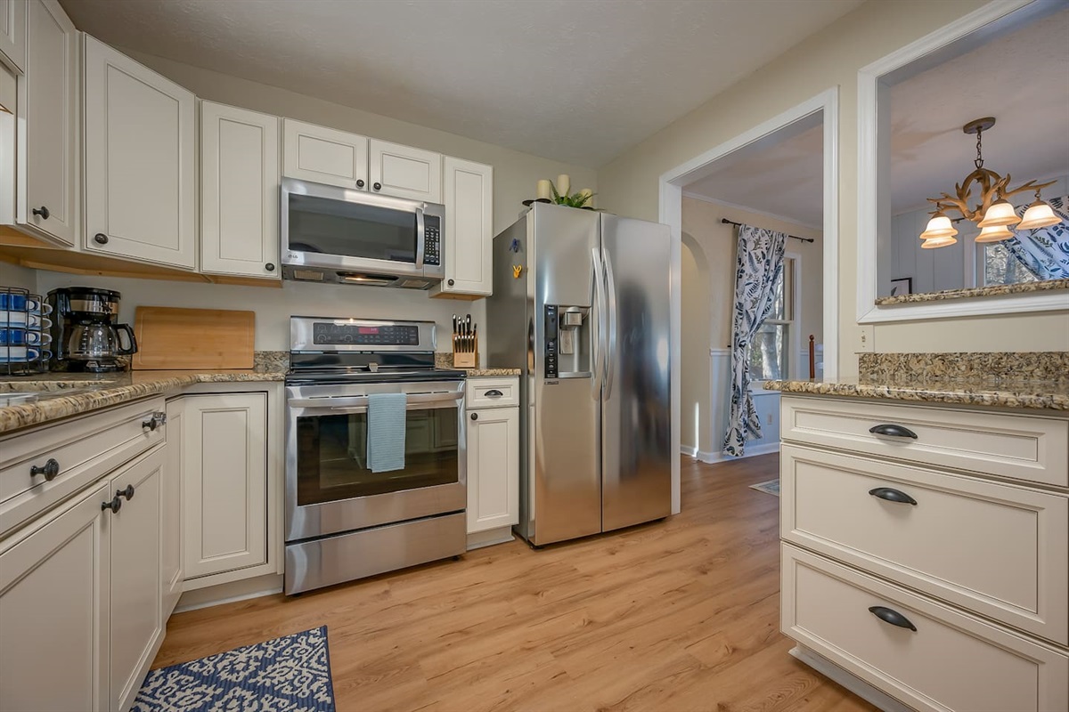 Updated kitchen with stainless steel appliances and countertops 