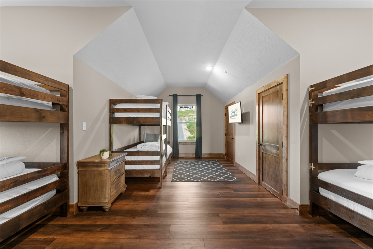 Upstairs bunk room with three twin bunks—sleeps six little (or grown-up) adventurers.