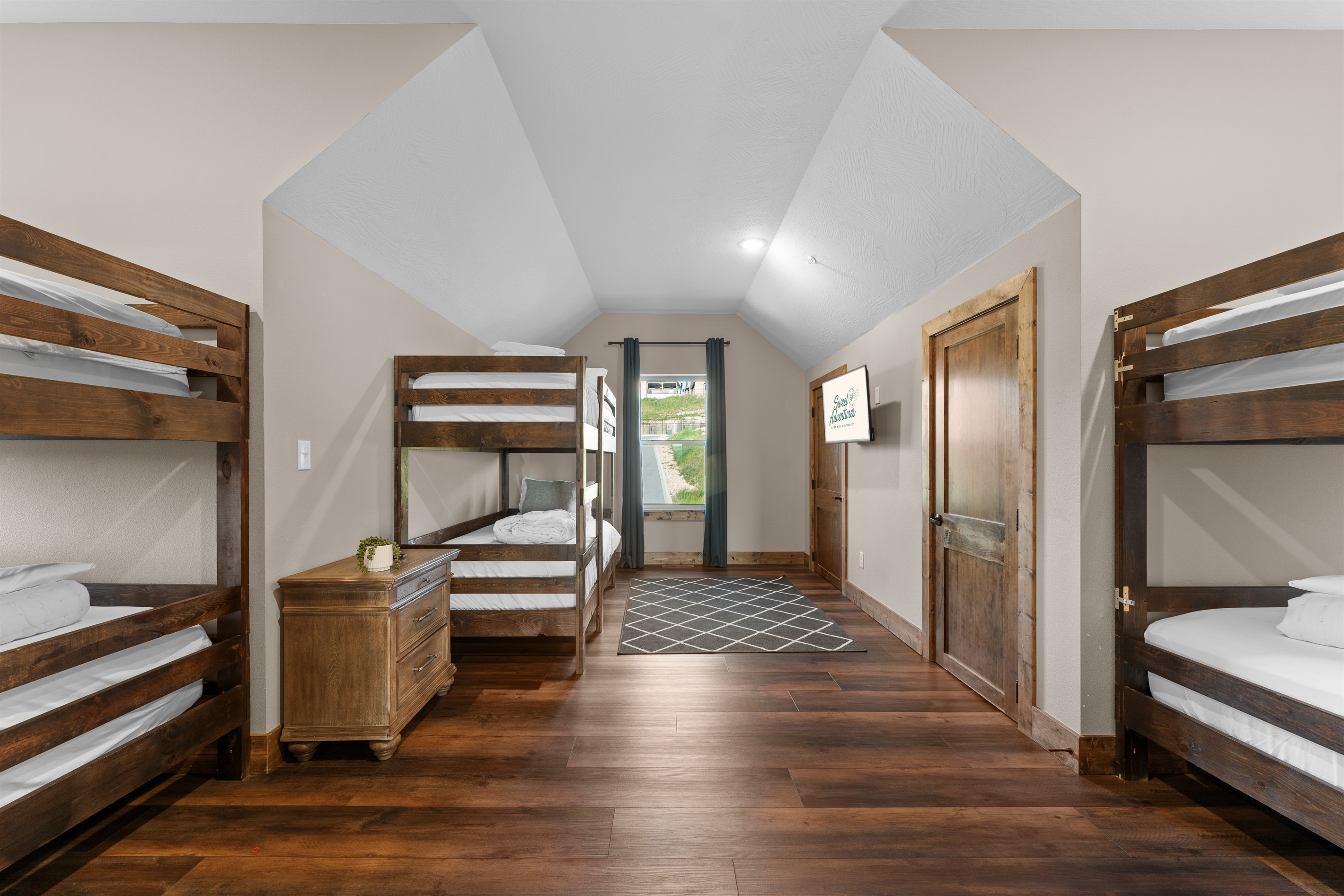 Upstairs bunk room with three twin bunks—sleeps six little (or grown-up) adventurers.