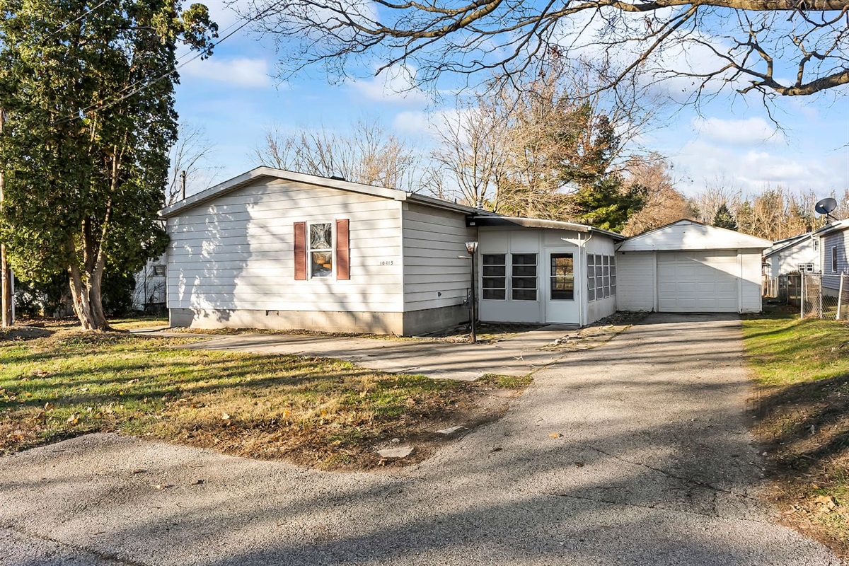 Detached single-car garage with paved driveway and easy access to the home.