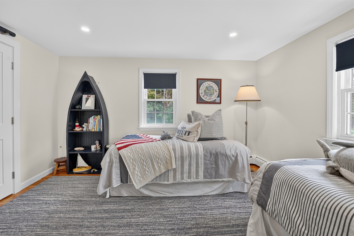 Unwind in the inviting fourth bedroom with two soft double beds for a good night’s rest!