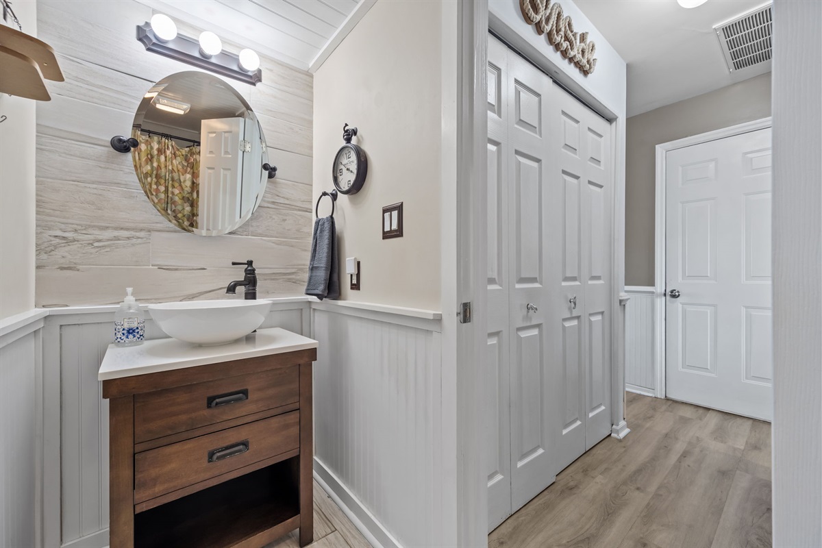 Main floor bathroom with vanity and storage closet