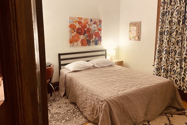 Queen bed with private desk and workspace.