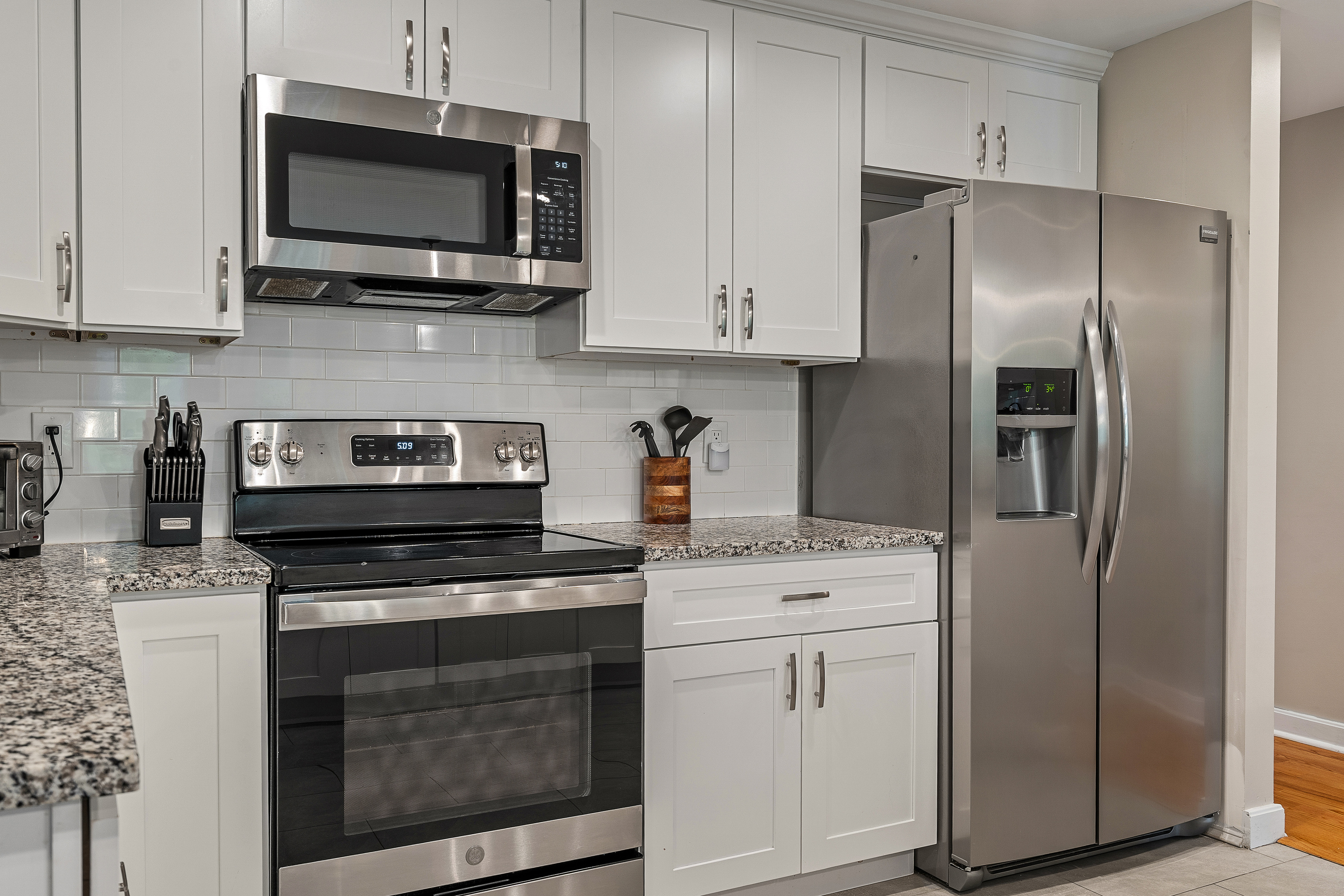 Stainless steel range, microwave and French-door refrigerator in the kitchen at First Chair Lair