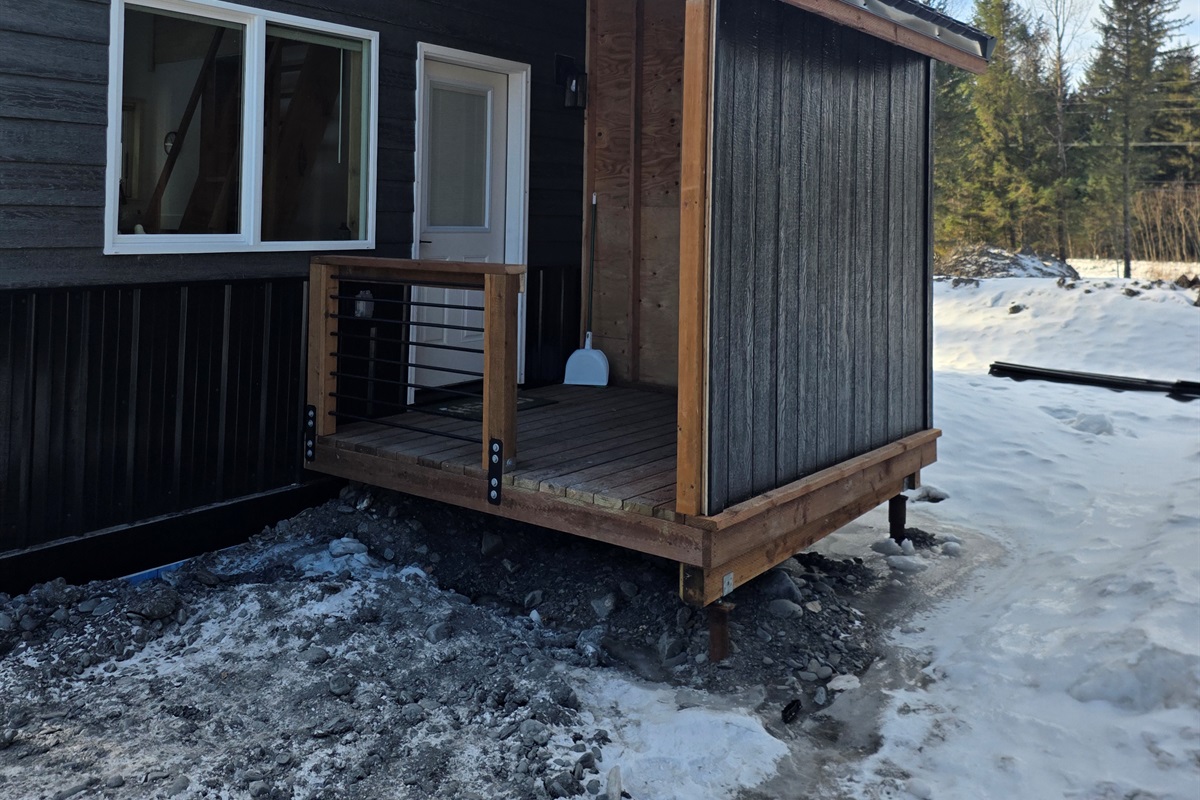 Cabin entrance with covered porch area.  There will be steps added to the porch and a freezer on the porch.