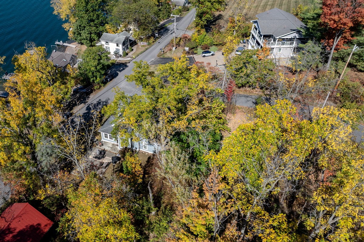 Nestled between trees, this cozy retreat is your upstate hideaway for all seasons