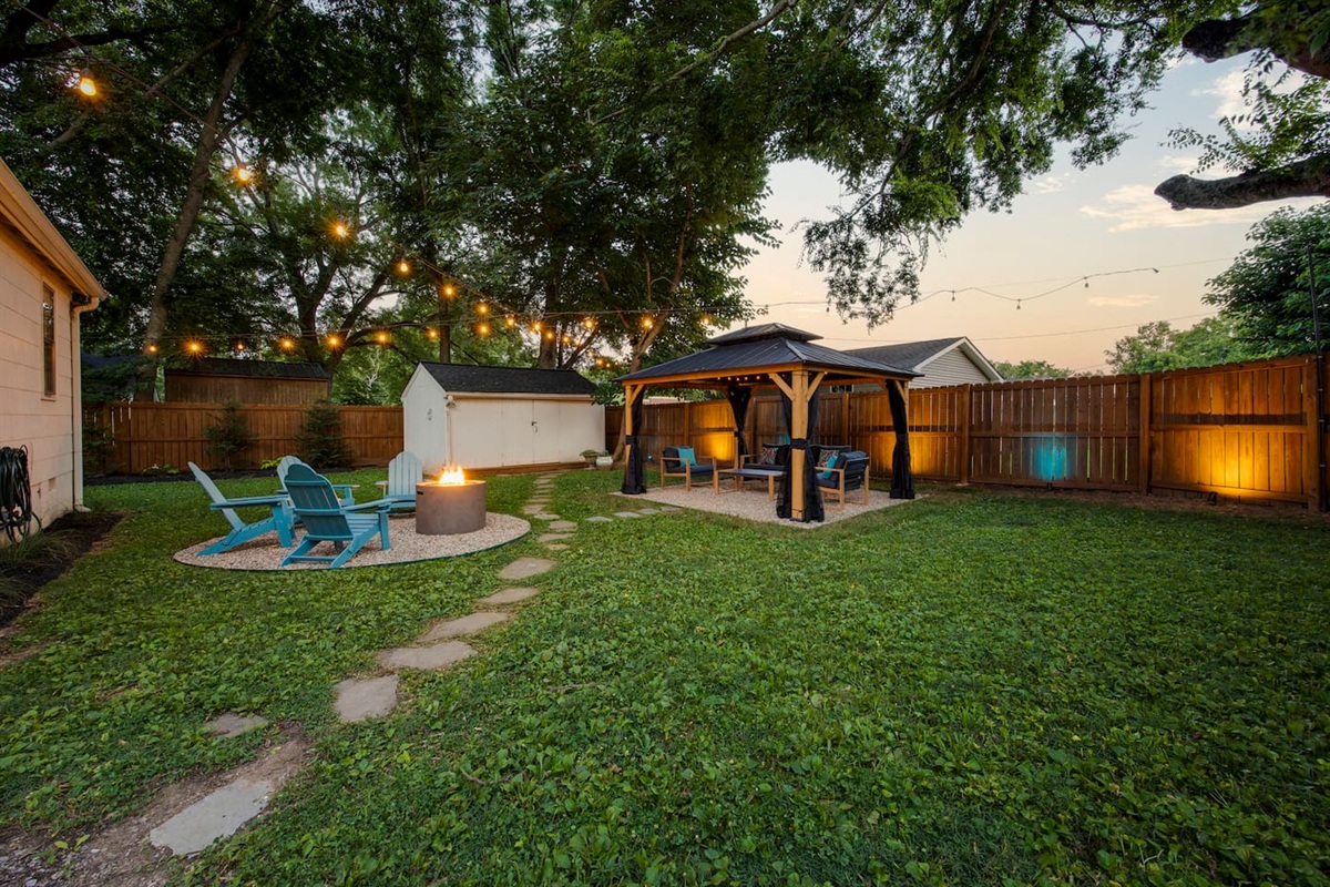 Backyard fire pit and seating area, covered gazebo hangout, and fully enclosed yard with privacy fence.