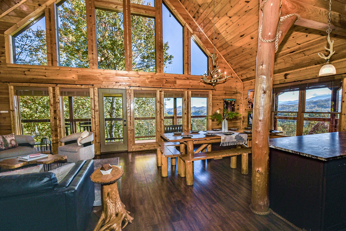Hand-hewn tree pillars, walls of windows and a large, open area for gathering, lounging and dining.