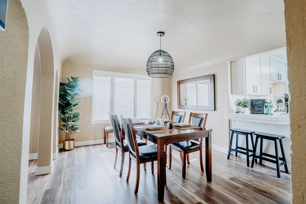 Dining area with table, chairs, counter, and bar stools