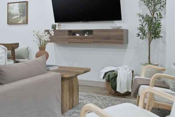 Relax and stream your favorite shows on the large wall-mounted TV from the comfort of the living room seating area.