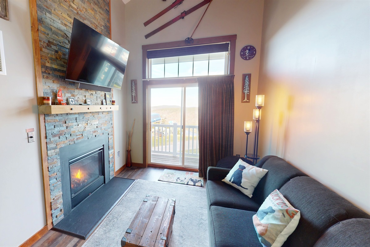 Cozy mountain living with stone fireplace & smart TV — perfect after a day on the slopes!