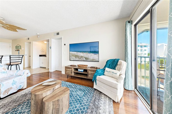 Comfortable living room with 65" smart TV and sleeper sofa.