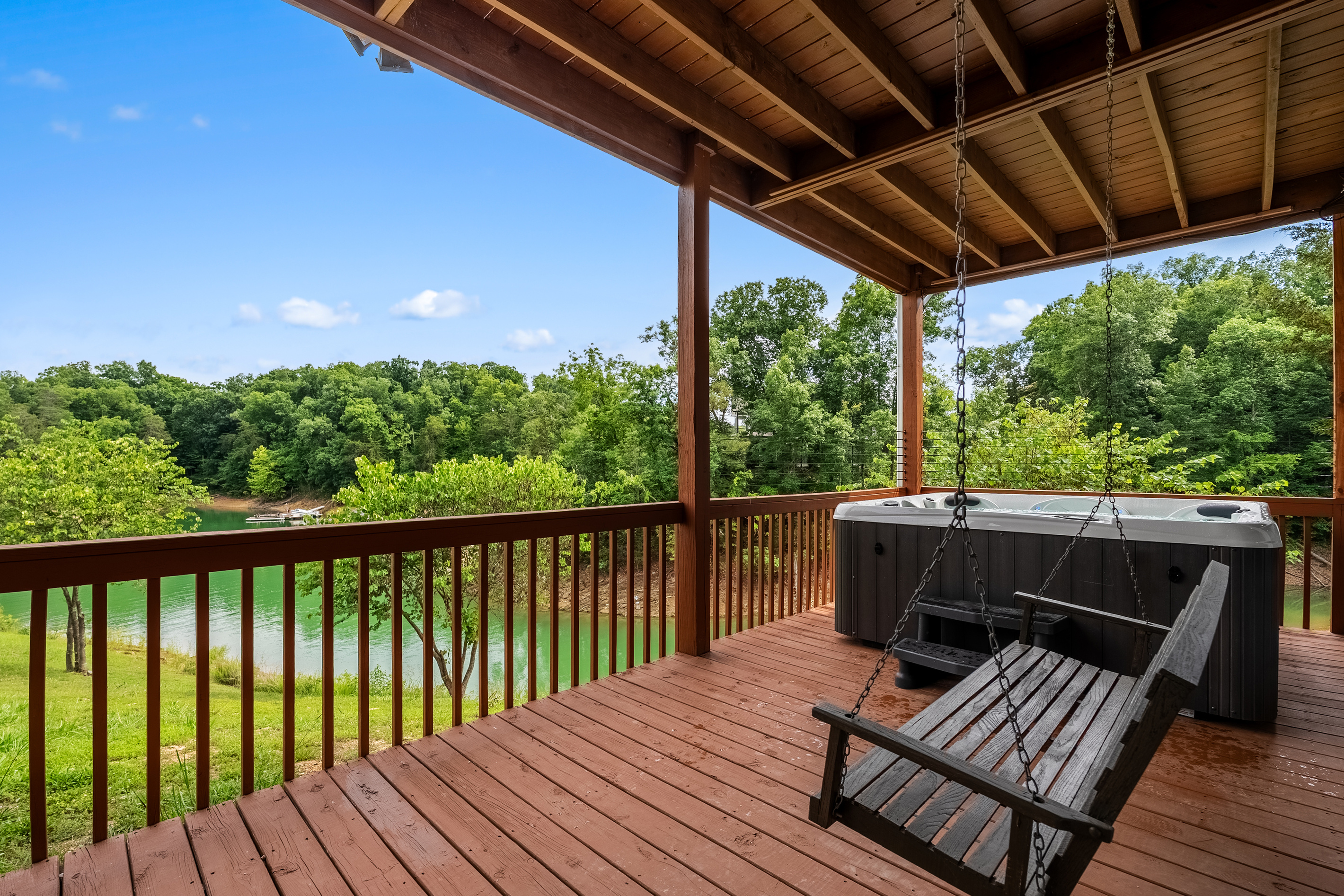 Outdoor dinning, hot tub and cozy seating from lower deck