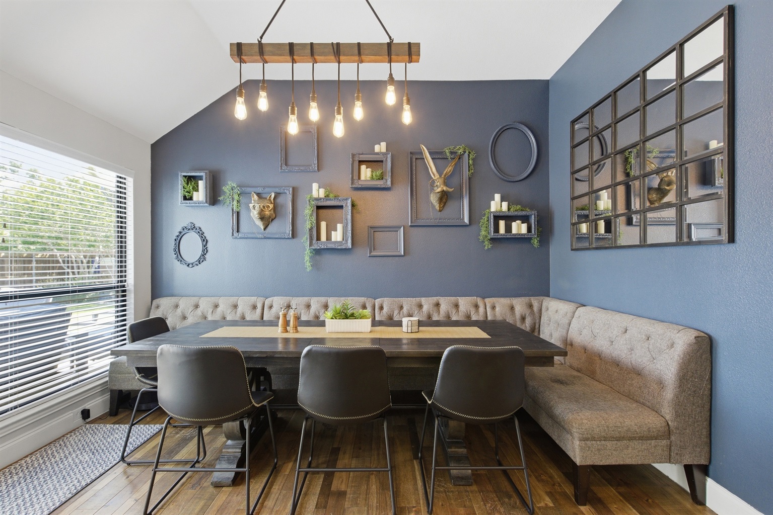 Dining Room with seating for 8, designer pendant lights, and a comfortable banquette ideal for family meals or game nights with the group.
