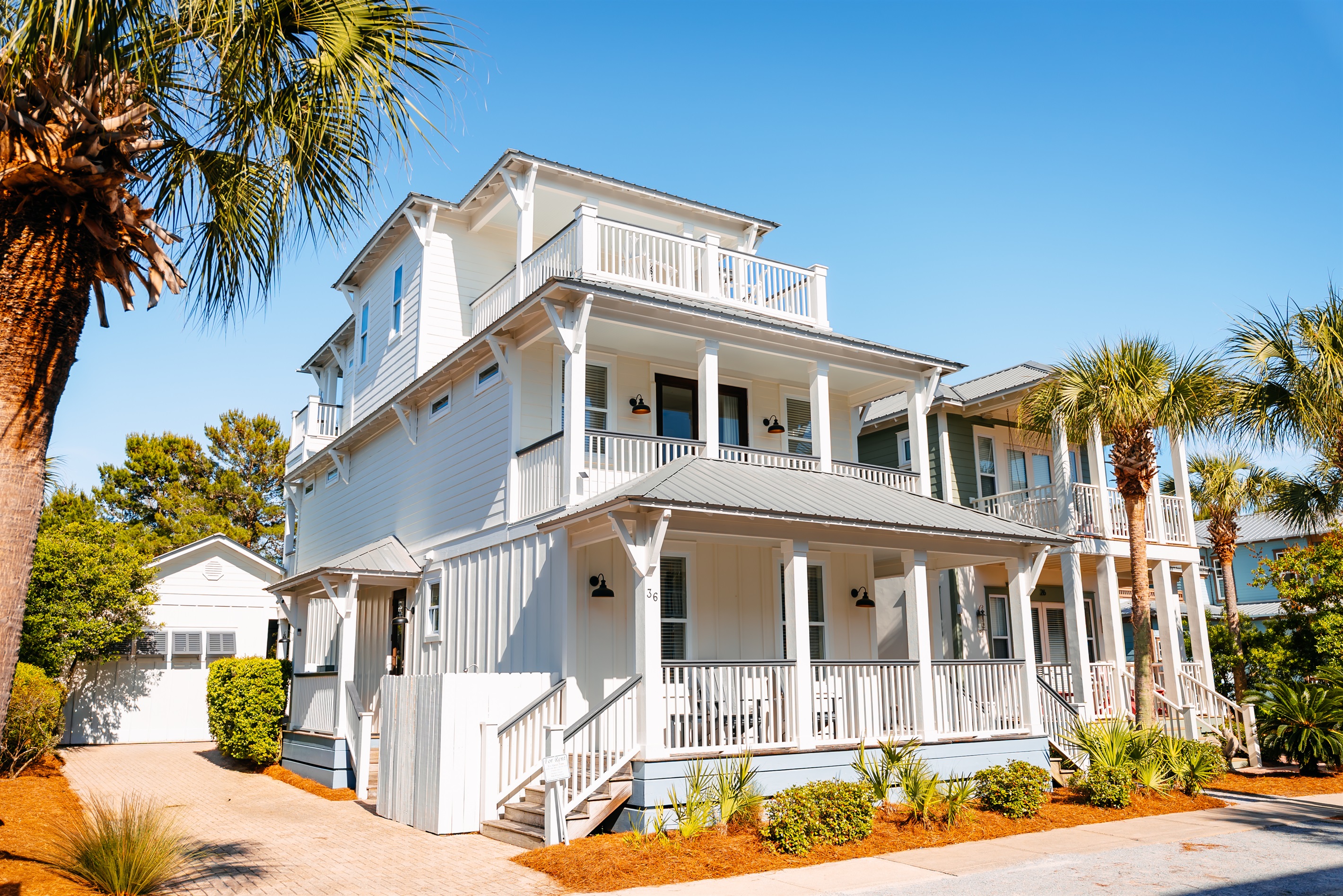 Bright 3-story home with separate carriage house, multiple porches and walkable access to the beach, pool, green space, restaurants and shops.