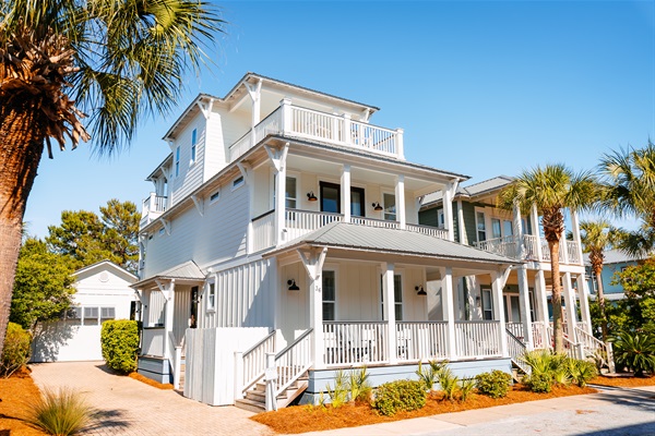 Bright 3-story home with separate carriage house, multiple porches and walkable access to the beach, pool, green space, restaurants and shops.
