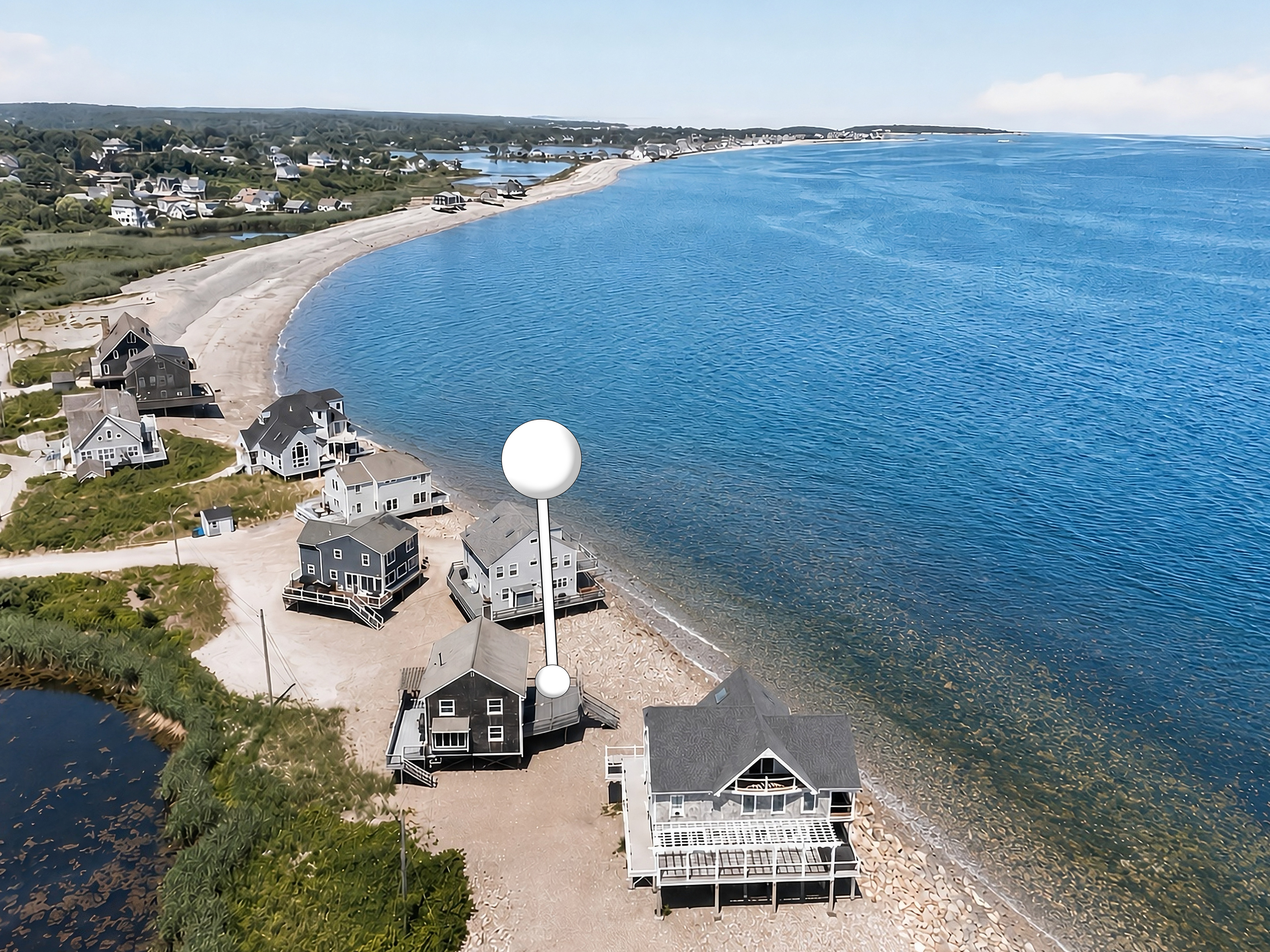 Aerial view showcasing this exceptional beachfront location with direct access to the shoreline and panoramic coastal views.