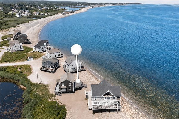 Aerial view showcasing this exceptional beachfront location with direct access to the shoreline and panoramic coastal views.
