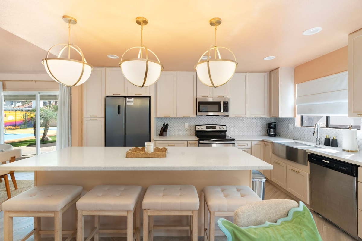 Stainless steel appliances and a farmhouse style sink in this well-equipped kitchen.