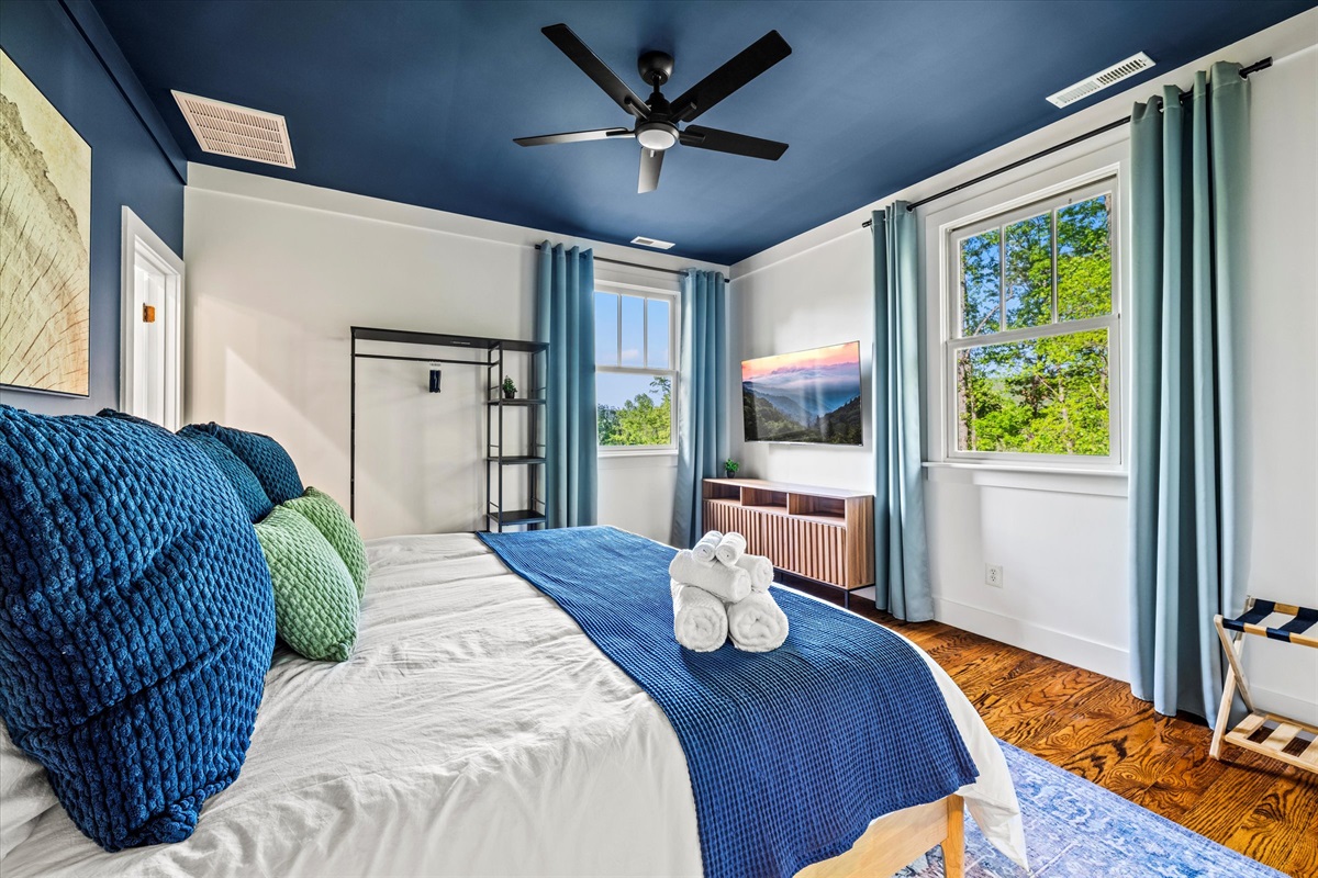 Wake up to treetop views and the soft morning light in this 2nd-level, calming king suite featuring plush textures, rich blues, and your own ensuite with a modern tiled shower.