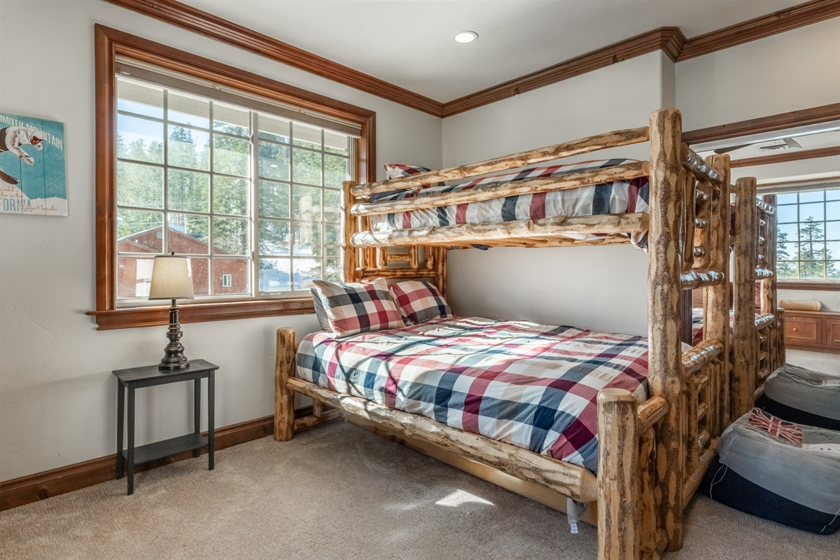 Handcrafted log bunk beds offer a fun, comfortable sleep setup for kids and adults alike.