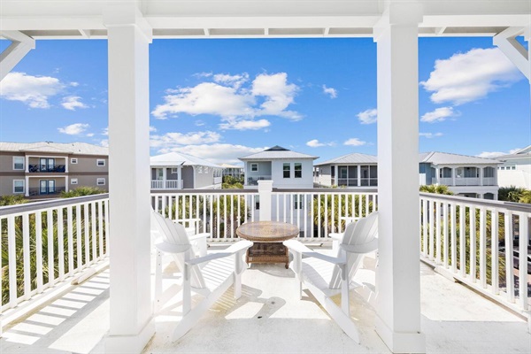 Enjoy morning coffee or sunset drinks on your private balcony with peaceful views of the charming beachside neighborhood. 