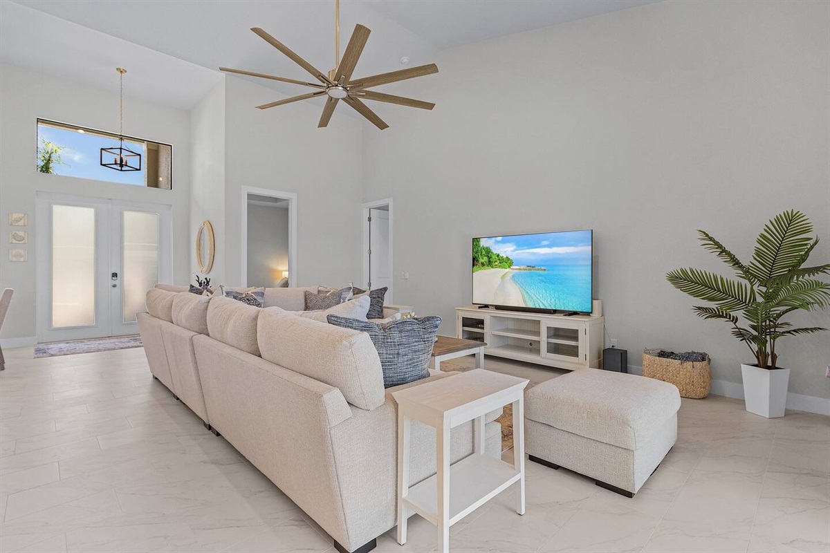 Step into a luxurious living room adorned with plush seating and a large TV, the perfect setting for cozy movie nights and ultimate relaxation!