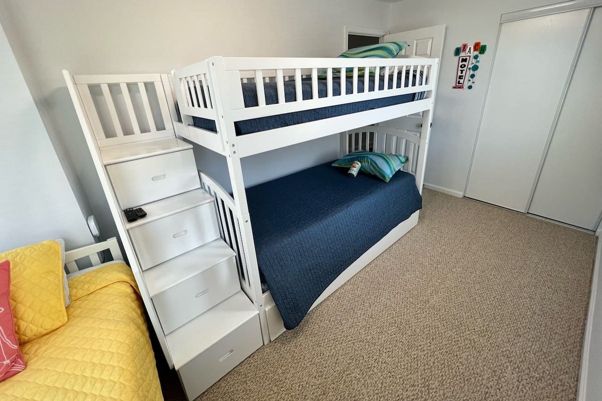 Guest room #2 with roomy drawer storage built in to the bunk bed steps